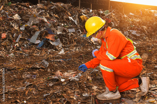 workers talking in recycling factory,a worker who recycling thing on recycle center,engineers standing in recycling center