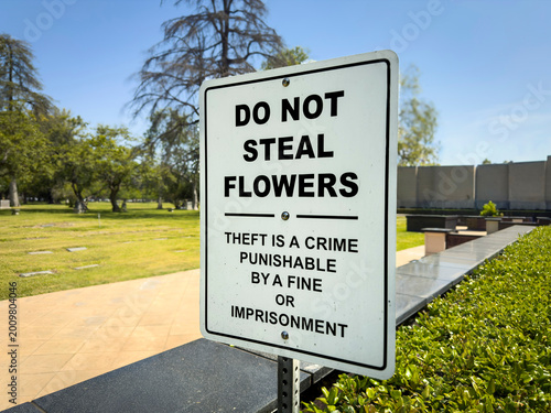 Photos A sign at a cemetery stating Do Not Seal Flowers punishable by fines or jail