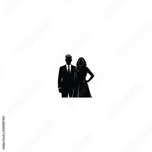 A man and woman stand together in formal attire on a city street.