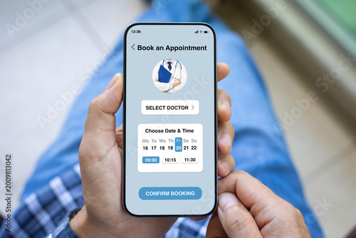 Man holding phone with medical doctor appointment booking app interface