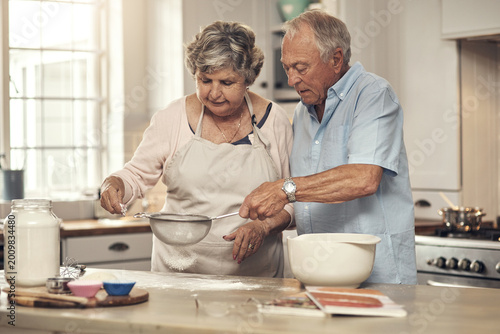 Fotografía Help, old couple and baking with flour in kitchen for cake recipe, retirement hobby and bonding