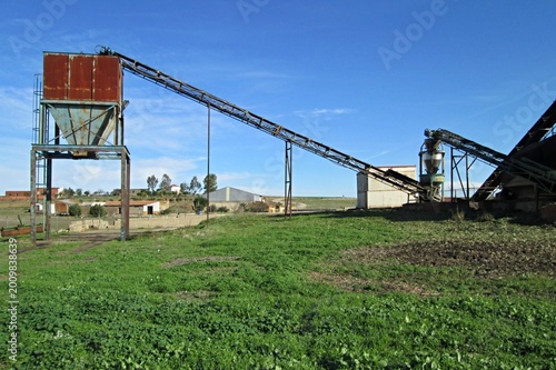 Industrial conveyor belt system processing materials outdoors