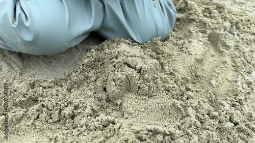 Child Playing with Sand Toys at the Beach Close-Up