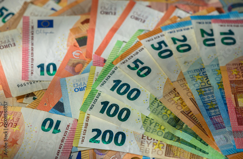 Scattered euro banknotes on wooden table