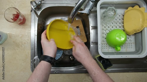 Washing Dishes in Kitchen Sink