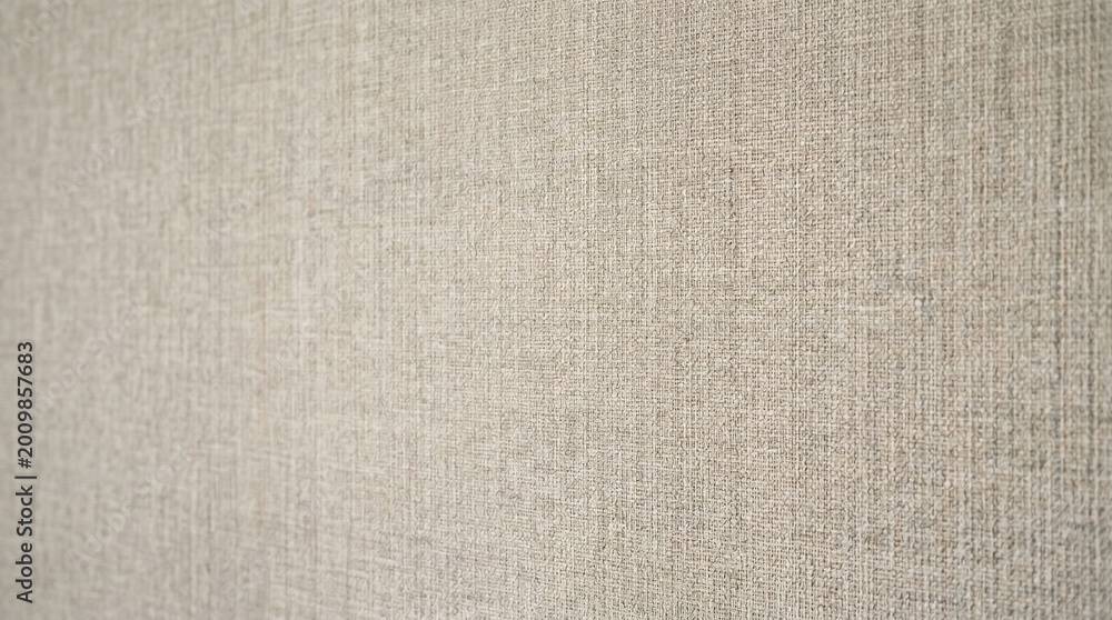 Fototapeta premium Soft Fabric Wall Texture with Subtle Weave Pattern in Warm Neutral Tones