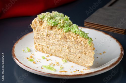 Napoleon cake, piece of crunchy pie on plate