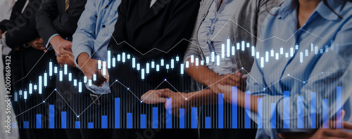 Canvastavla A focused group of professionals observes financial graphs and data trends during a business presentation, highlighting investment analysis in a corporate environment