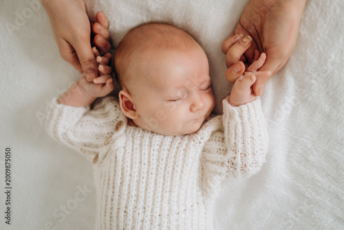a newborn baby is sleeping, a sweet healthy baby's sleep on a white bed, space and room for text