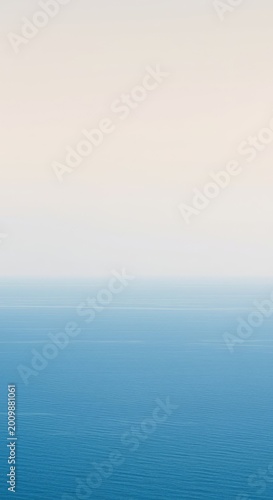 A tranquil, ultra-minimalist horizon where a calm, clear blue ocean meets a soft, pale sky, suggesting vast open space and profound serenity ,smooth ,future ,space