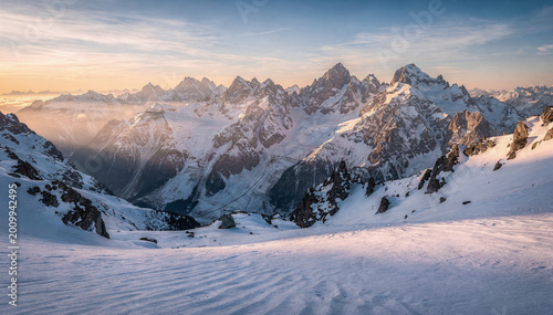 Majestic winter mountains with soft sunset light and snowy peaks