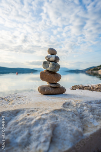 Balanced Stone Stack on Seaside With Dramatic Cloudy Sky – Zen and Harmony Concept