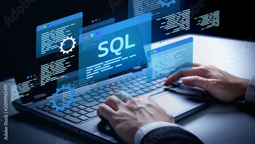SQL Programming in Action: A software developer is engrossed in crafting the digital future with the power of SQL, working in a modern environment