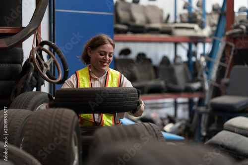 Female warehouse worker or Automotive parts warehouse staff check wheel or tire in auto parts warehouse