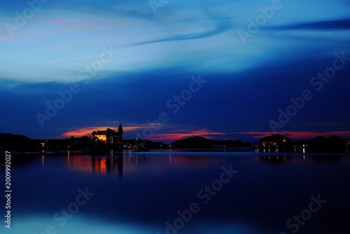 Blue hour waterfront landscape with dramatic cloud reflection and tranquil twilight scenery