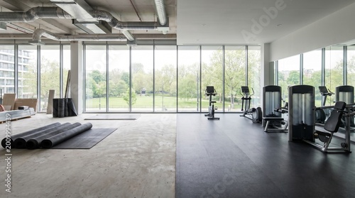 Gym renovation progress with before and after construction phases