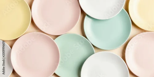 Panel kuchenny z motywem Soft pastel plates overlap in modern abstract arrangement. Yellow pink mint white dishes create gentle visual texture on light background. Clean simple art for home decor.