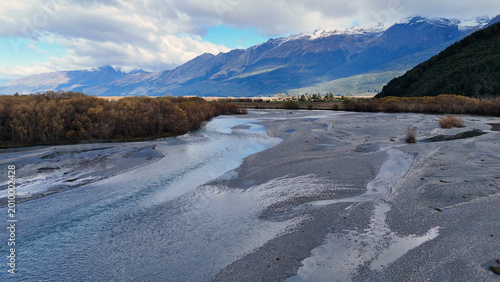 Tableau sur toile Aerial View of Braided River in Glenorchy Valley with Snow-Capped Mountains