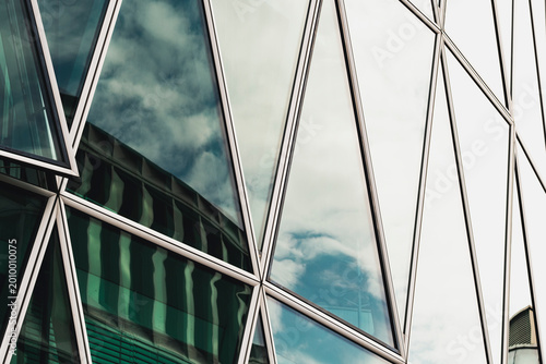 Triangles on a glass facade frame windows reflections with bold geometry and pattern creating modern abstract background for design layouts