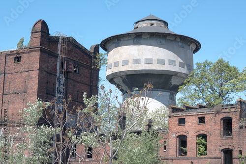 Fotografie Ruins of an old brick factory and water tower.