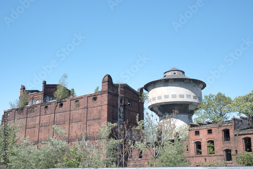 Fotografie Ruins of an old brick factory and water tower.