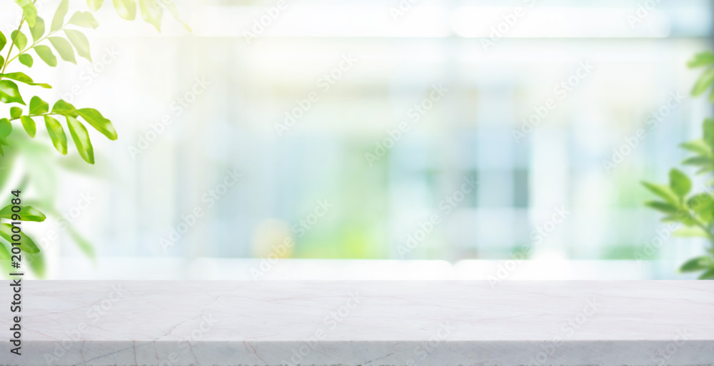 Obraz premium Selective focus.Elegance product display background with marble top on blur big window with fresh green leaf