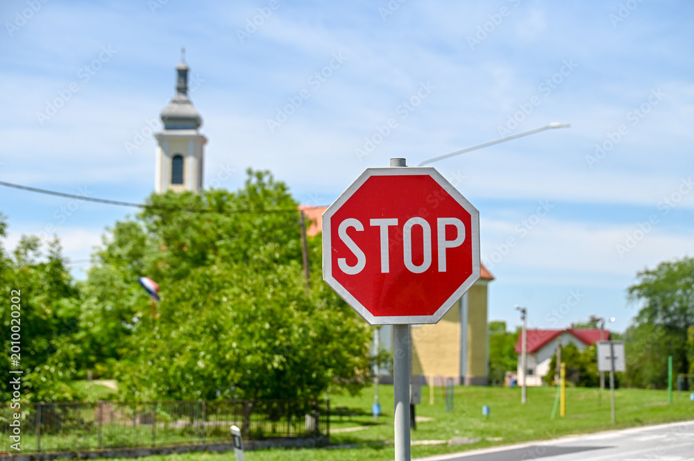 Foto Stop traffic sign at road intersection