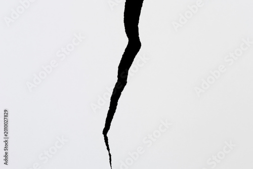 two pieces of torn white paper against black backdrop