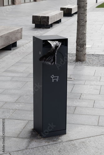 Dog waste station with plastic bags and waste bin at the street of London.