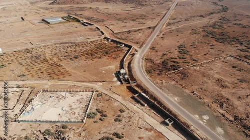 Panoramic aerial video of a winding road through the arid landscape of Socotra Island, ideal for themes of travel, remote infrastructure, and exploration