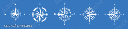 Fotografía Compass symbol with navigation directions and wind rose on blue background in mo