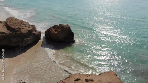 Panoramic aerial video of Socotra Island's unique rock arch formation on a pristine beach, showcasing natural beauty and adventure