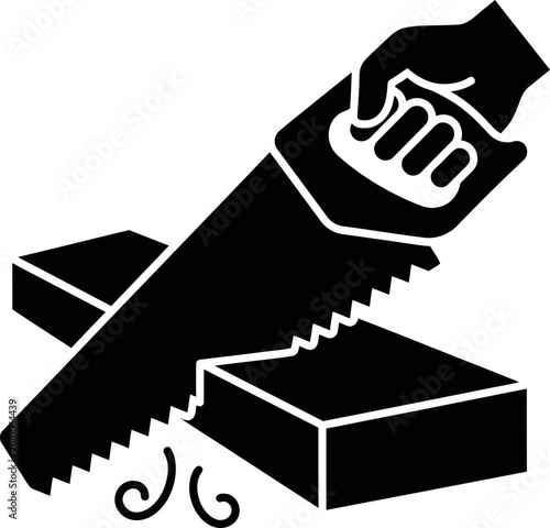 Fotografija Hand holding a saw cutting through a wood block