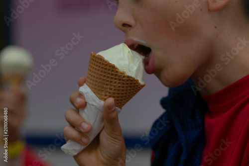 Konstfotografi teen eating waffle cone ice cream in street closeup of mouth and hand capturing