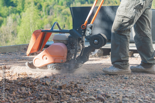 Fotografie Compactor creating dust cloud