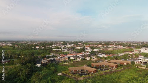 Canggu Bali 4K drone aerial of lush rice fields in late afternoon light, tropical landscape with green paddies, rural scenery and soft natural lighting, Southeast Asia travel destination.
