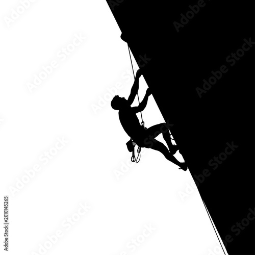 Schilderij op canvas Silhouette of a male rock climber scaling a steep imposing cliff face showcasing