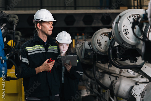 Fotografi Repair specialist inspects machinery in factory ensuring industry standards are