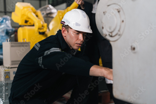 Valokuva Repair specialist inspects machinery in factory ensuring industry standards are