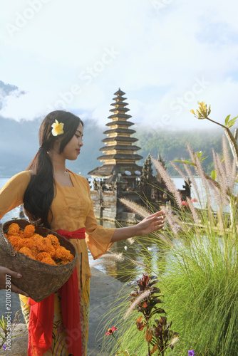 Bali Lady in Traditional dress walk in old temple, indonesia