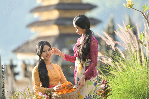 Bali Lady in Traditional dress walk in old temple, indonesia