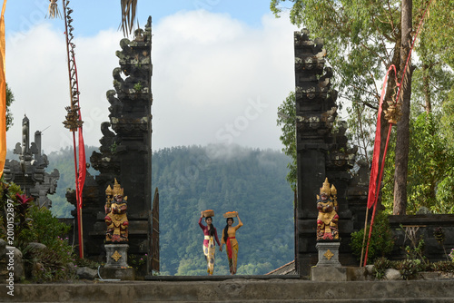 Bali Lady in Traditional dress walk in old temple, indonesia