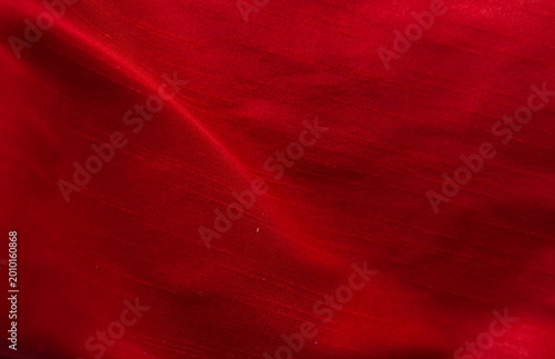 The red satin fabric ripples beautifully as a backdrop.