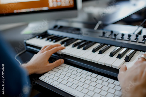 Obraz na plátně composer hands on piano keys in recording studio