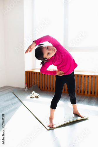 Photography Little girl is doing Back tilt standing workout at home