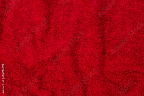 Billede på lærred Bright red fabric draped on a flat surface in a well-lit room during the day