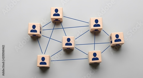Abstract representation of a social or business network with wooden blocks featuring person icons connected by blue lines.