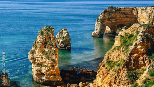 Aerial view of rocky coastal formations above turquoise sea in Portugal. Algarve. Beach