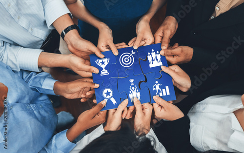 Cuadro en lienzo Diverse corporate officer workers collaborate in office, connecting puzzle pieces to represent partnership and teamwork