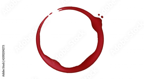 A circular red wine stain or ring mark isolated on a solid black background, creating a textured liquid spill pattern with droplets